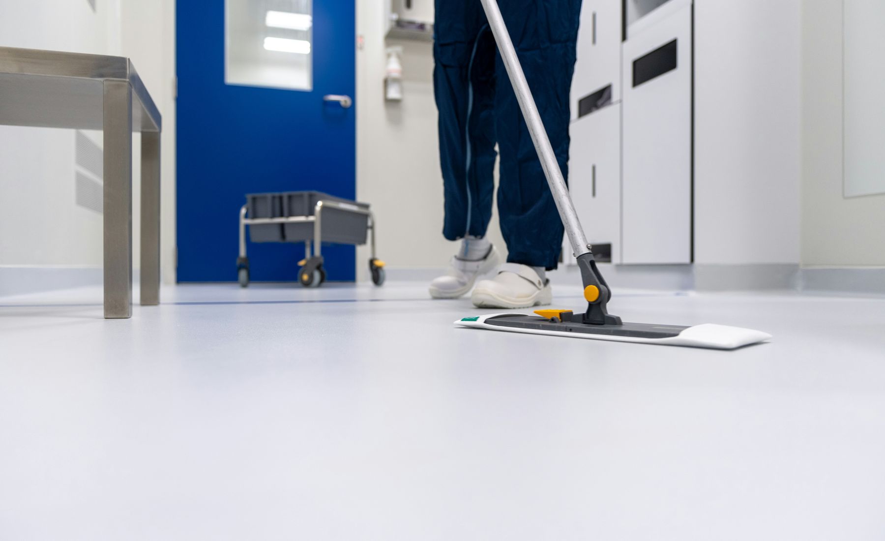 A cleaner working in a commercial lobby at first light