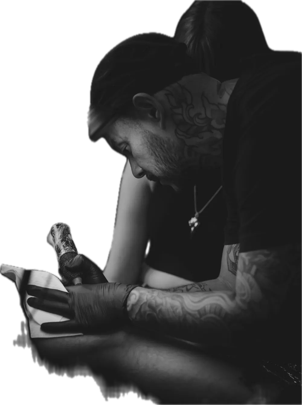 Tattoo artist working on a client's hand