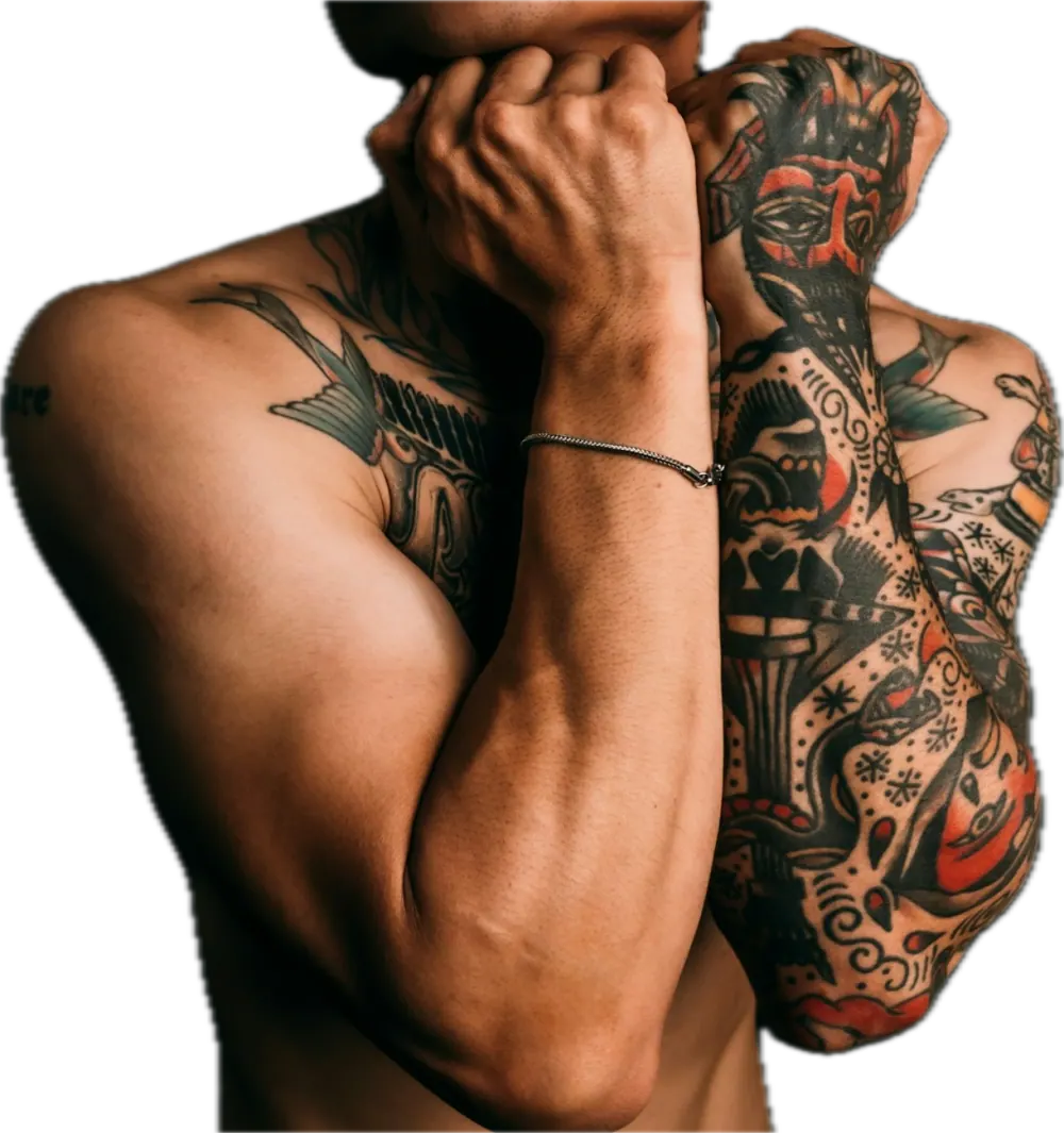 Man with fully tattooed arms crossed in front of his face